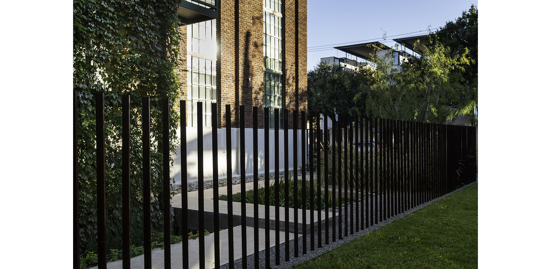Cantilevered Steel Picket Fence and Vine Covered Stair Tower