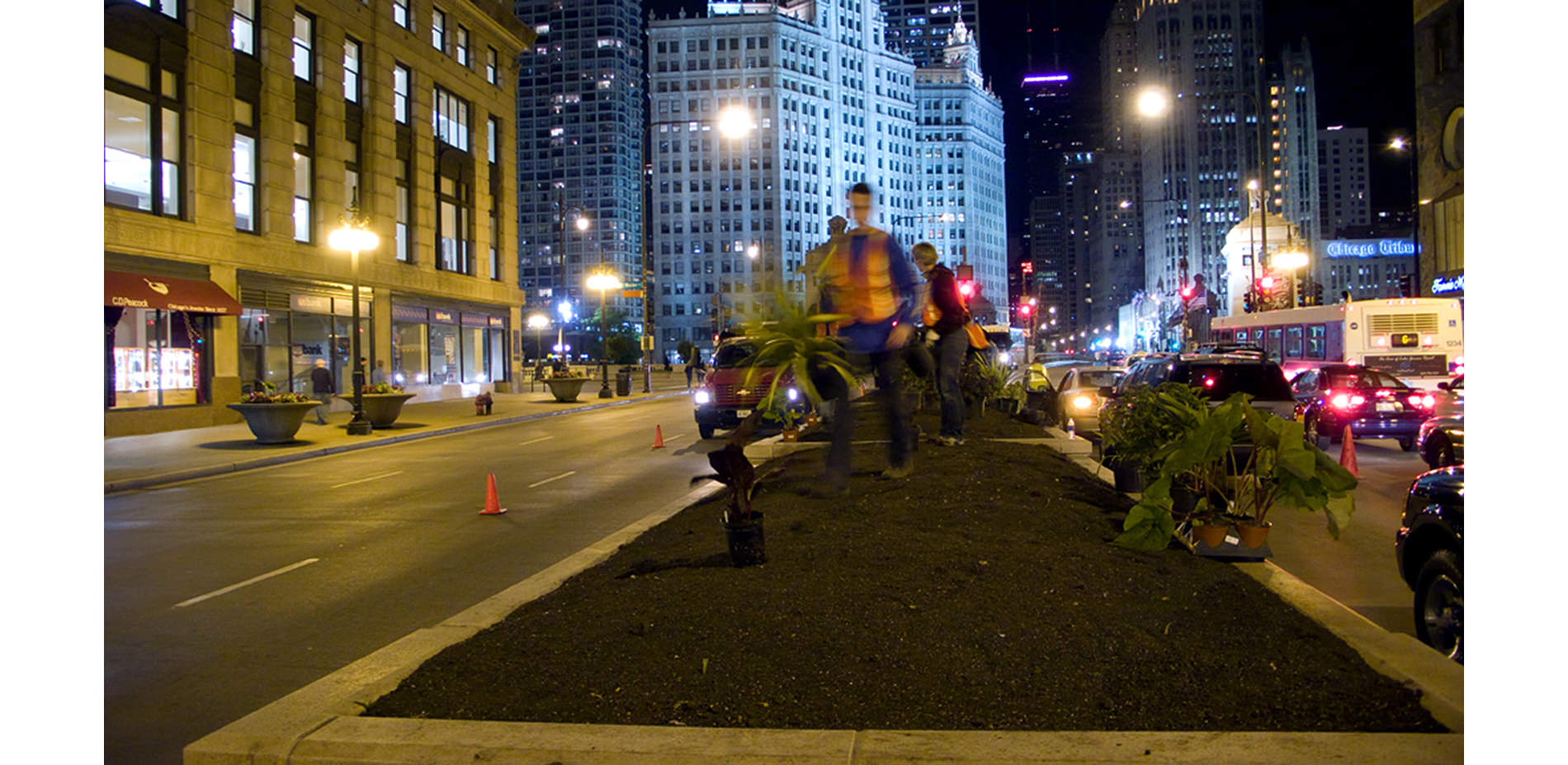 Workers Switching Planter Display at Night