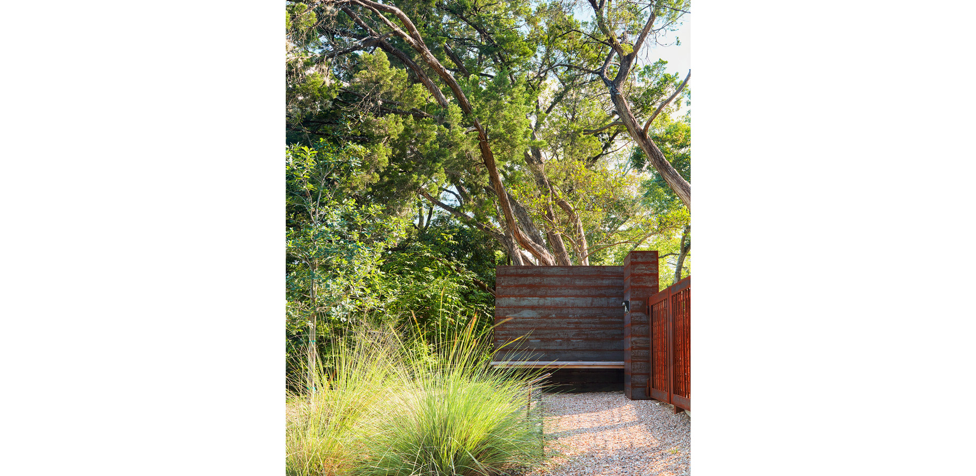 A steel and wood bench at the entry gate provides an invitation to stop and enjoy the garden.…