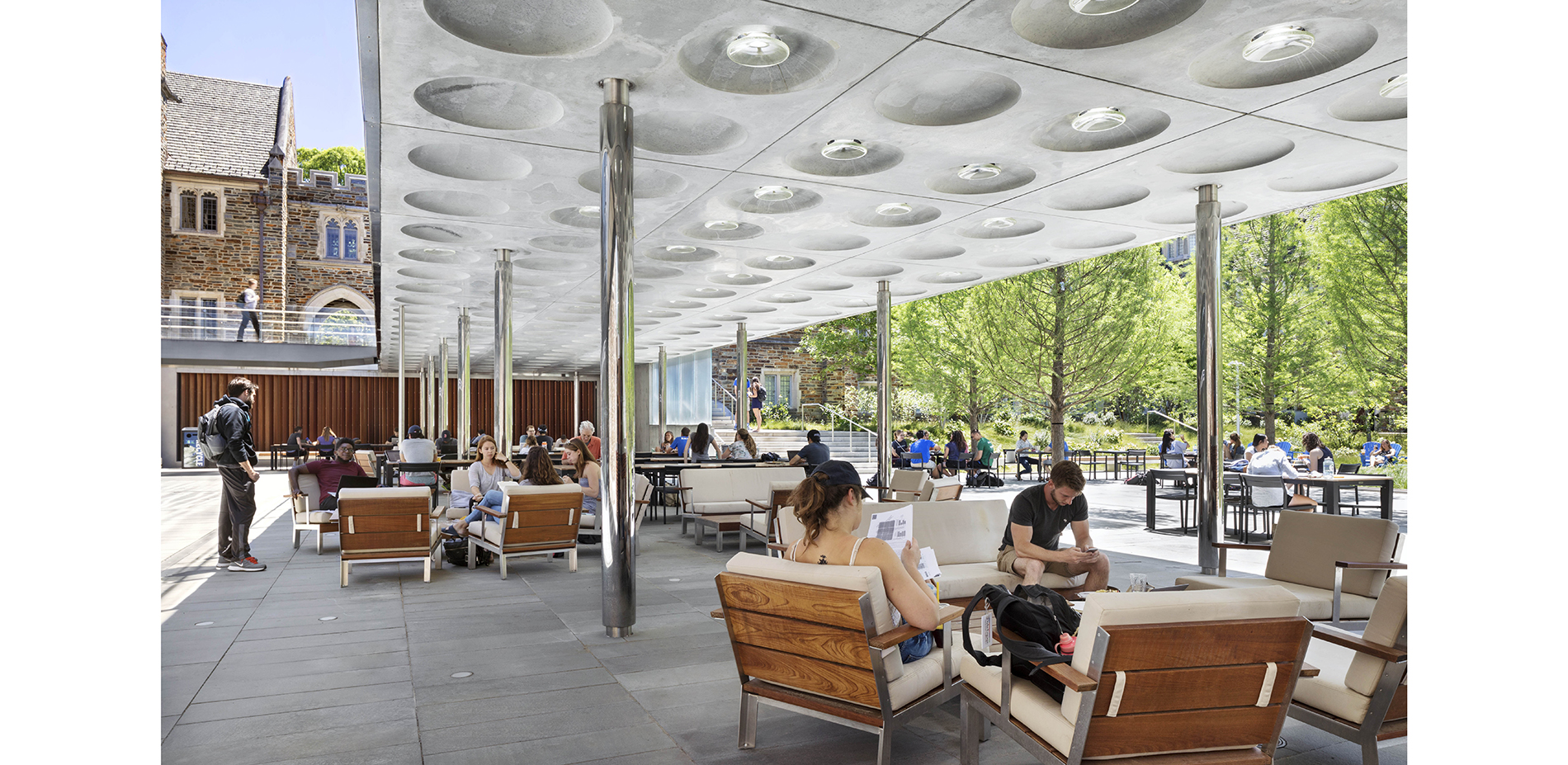 The elevated pedestrian bridge provides for shady relaxation at the garden's edge. Glass lenses embedded overhead transmit light and playful shadows b…