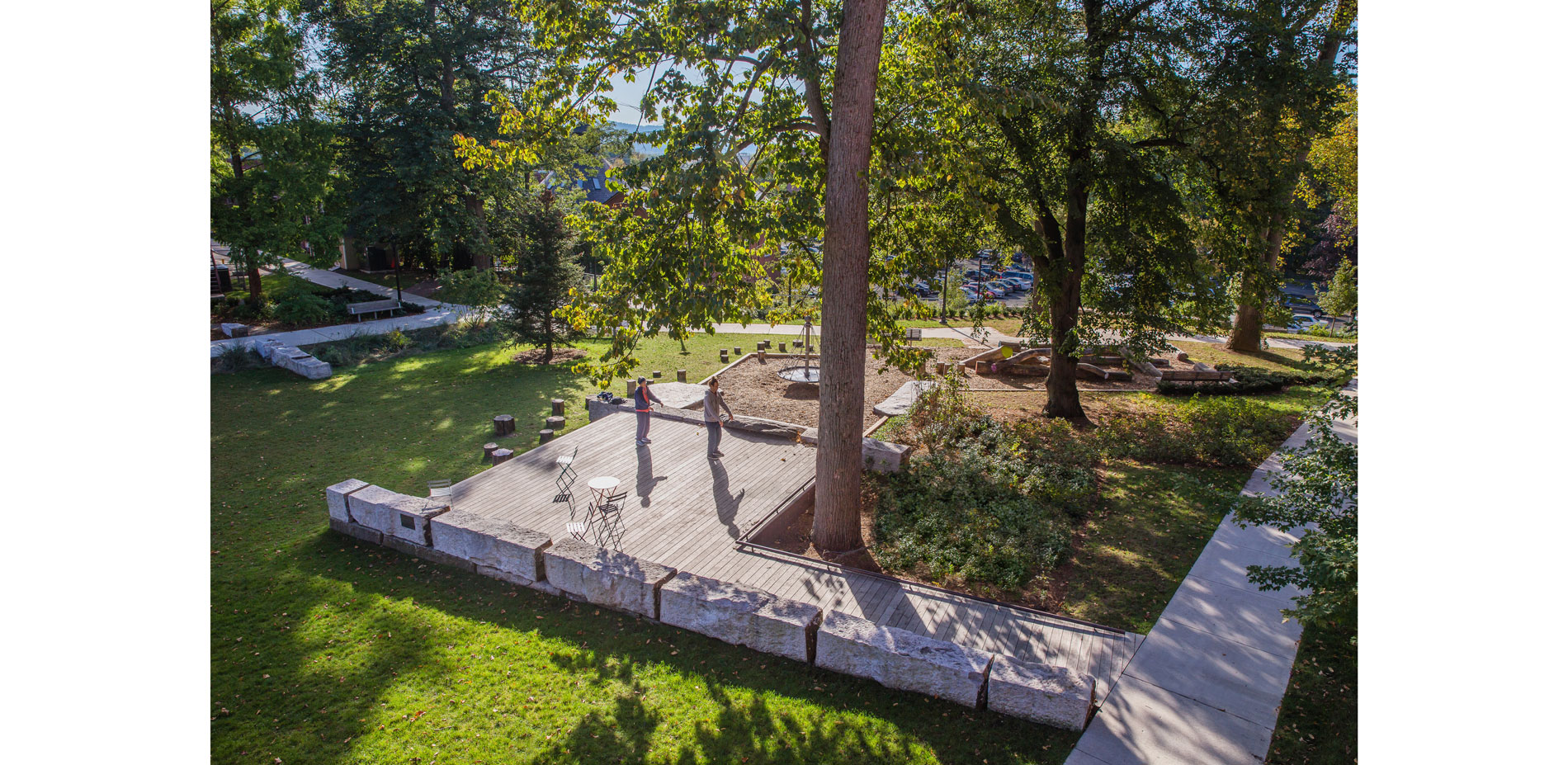 Parents requested a place of their own while their kids could play. An accessible black locust deck with moveable furniture hovers sensitively above t…