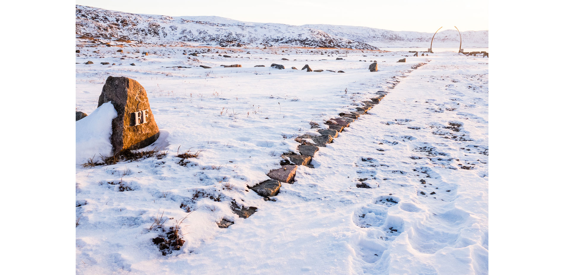 The central axial pathway terminates at an archway of standing bowhead whale jaw bones…