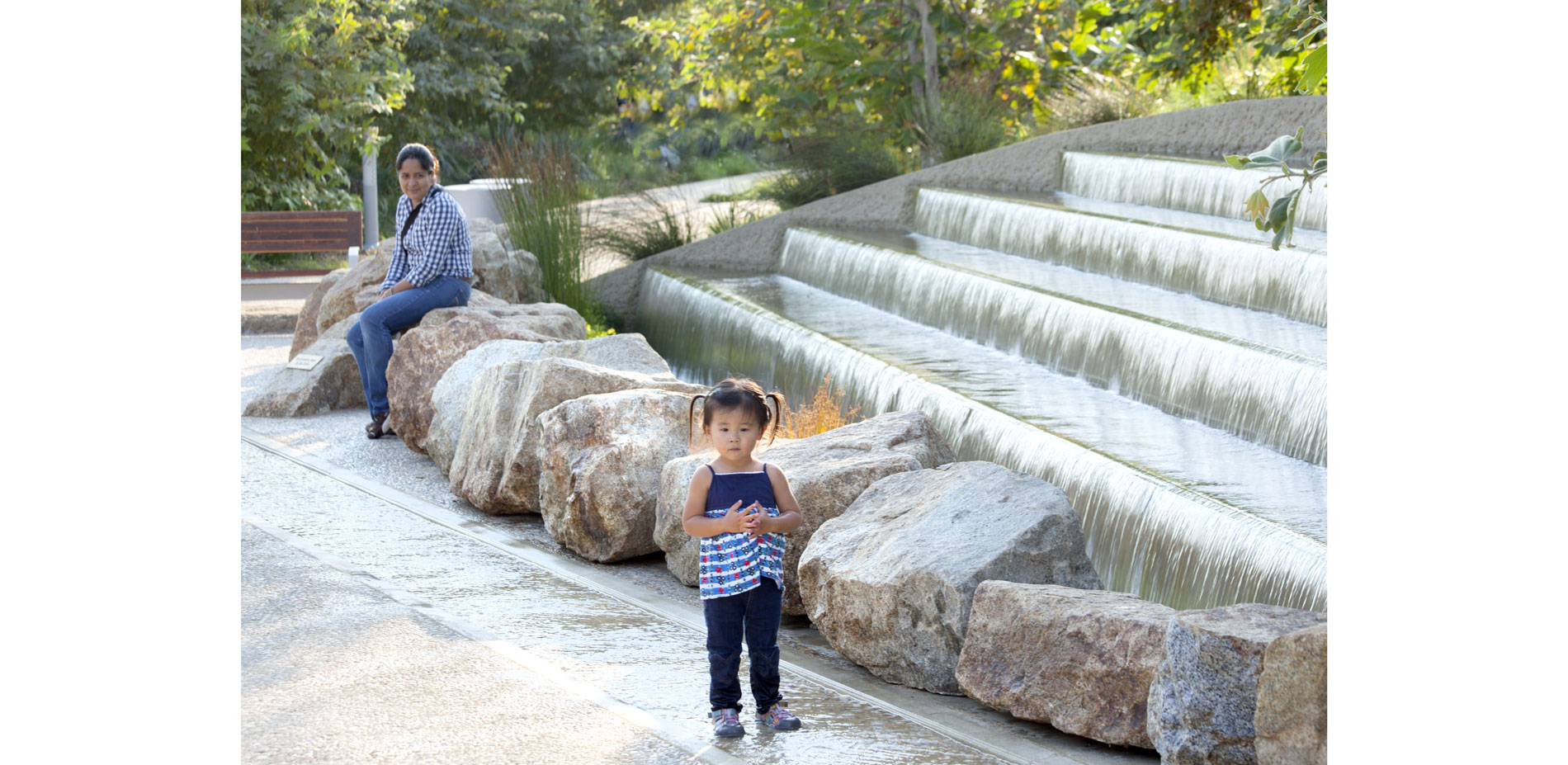 A scooped out bay along the park’s  central path is the backdrop for a sparkling waterfall sequence. Large boulders in front of the garden pool provid…