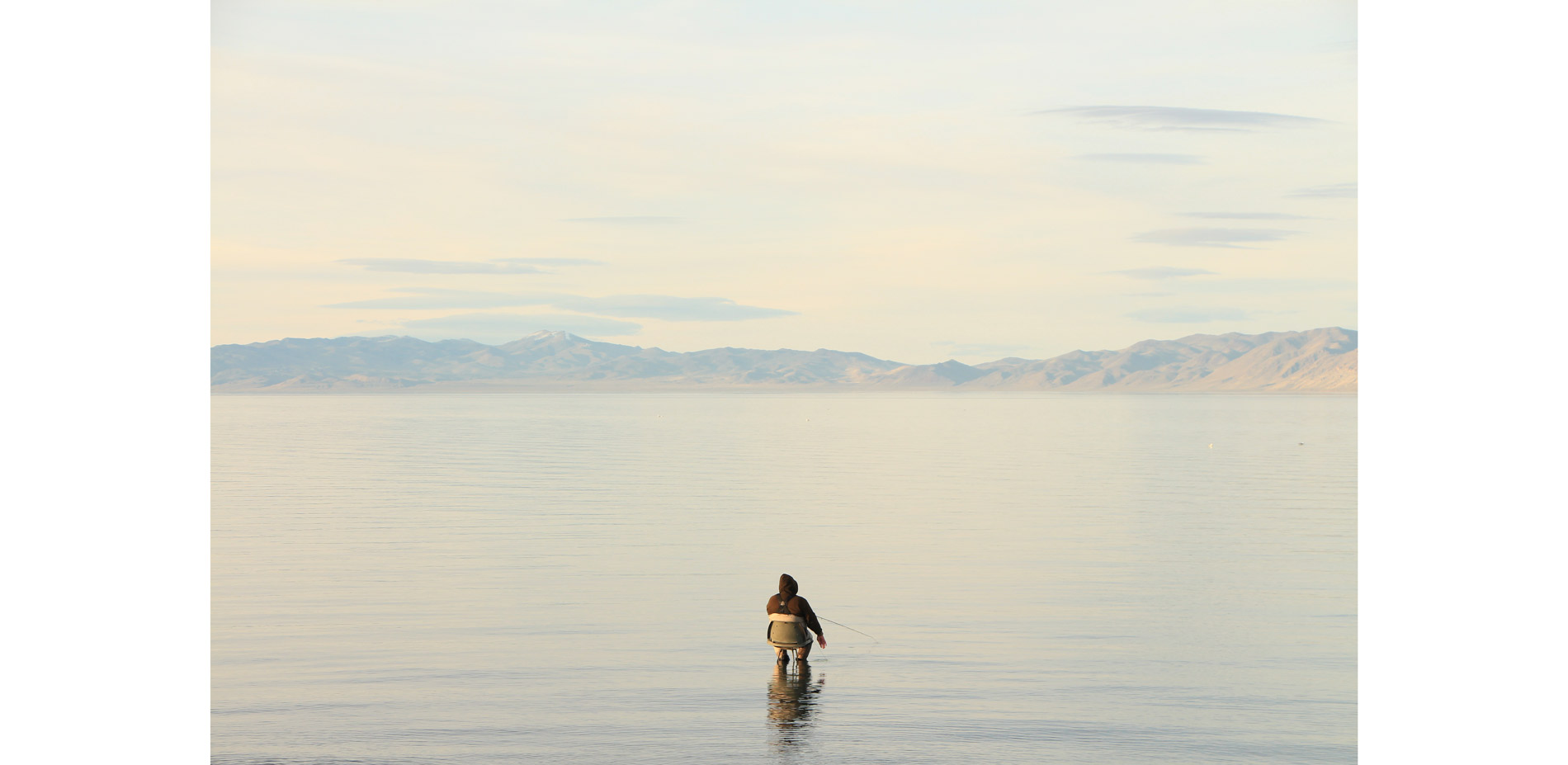 Pyramid Lake fades into the horizon at dusk, an expanse reminiscent of the ocean. Fisherman trying their luck at catching the prized Lahanton Cuthroat…