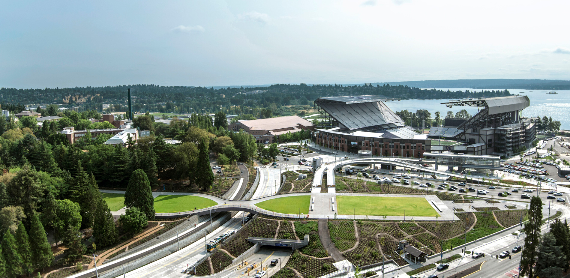 View of the Pedestrian Land Bridge looking toward the new light rail station, Husky Stadium, and Lake Washington