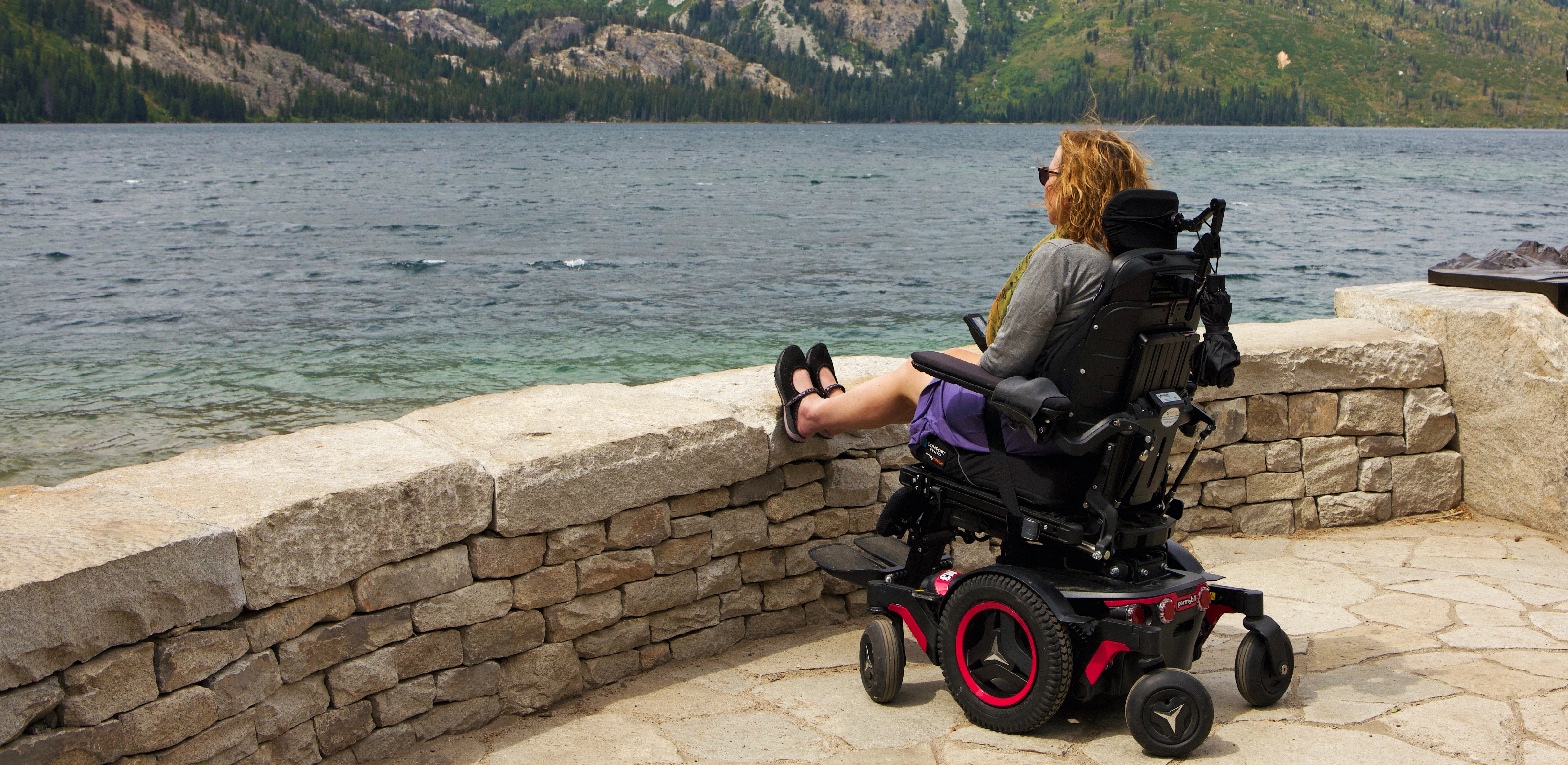 Image of woman in a wheelchair overlooking a body of water in Grand Teton National Park.