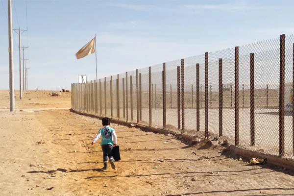 A young girl walking to school in the Al-Za’atari refugee camp, January 2014  image: Malda Takieddine