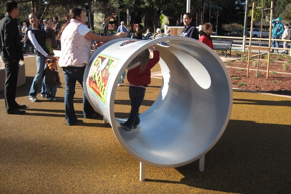 An over-size “canned cherries” crawl-through tunnel provides space for resting, hiding, and exploring. Stojanovich Family Park designed by Callander Associates in Campbell, CA. image: Callander Associates