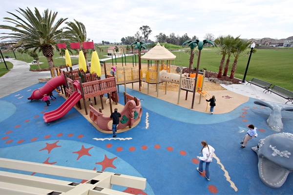 Sailing ship play structures, palm trees, and a precast whale climber set the scene for deserted-island adventures in Shasta Park in Sacramento, CA, designed by Callander Associates. image: Billy Hustace