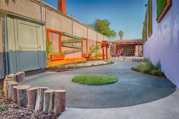 After. View looking North. The periwinkle wall helps to soften the building and reduce sun reflection while creating a calming atmosphere for the children. image: Alex Calegari