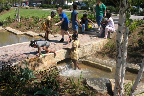 Birmingham’s Railroad Park has catalyzed development downtown and significantly reduced local flooding thanks to a one-acre lake that doubles as a detention basin, a recreated stream system, and other green infrastructure. image: Tom Leader Studio