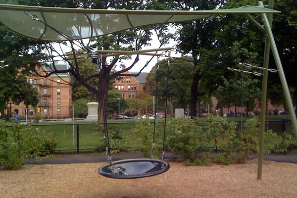 Swings that allow children to sit or lie in promote inclusivity because the same swing can be used different ways while still maintaining the basic purpose of the activity. image: Amy Wagenfeld