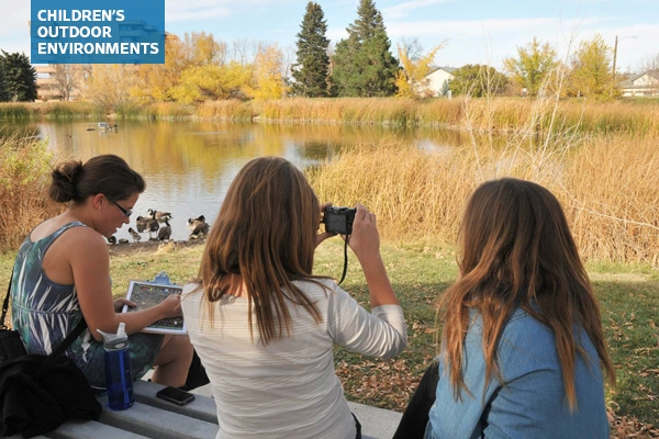 Middle school students documenting a site with photos