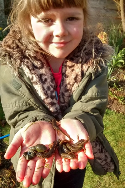 Esme holding newts