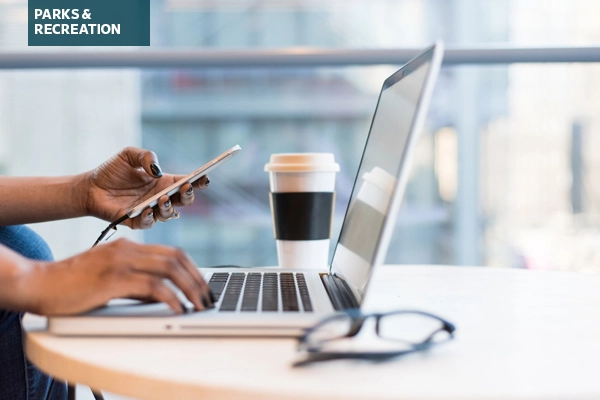 Woman using a laptop and smartphone