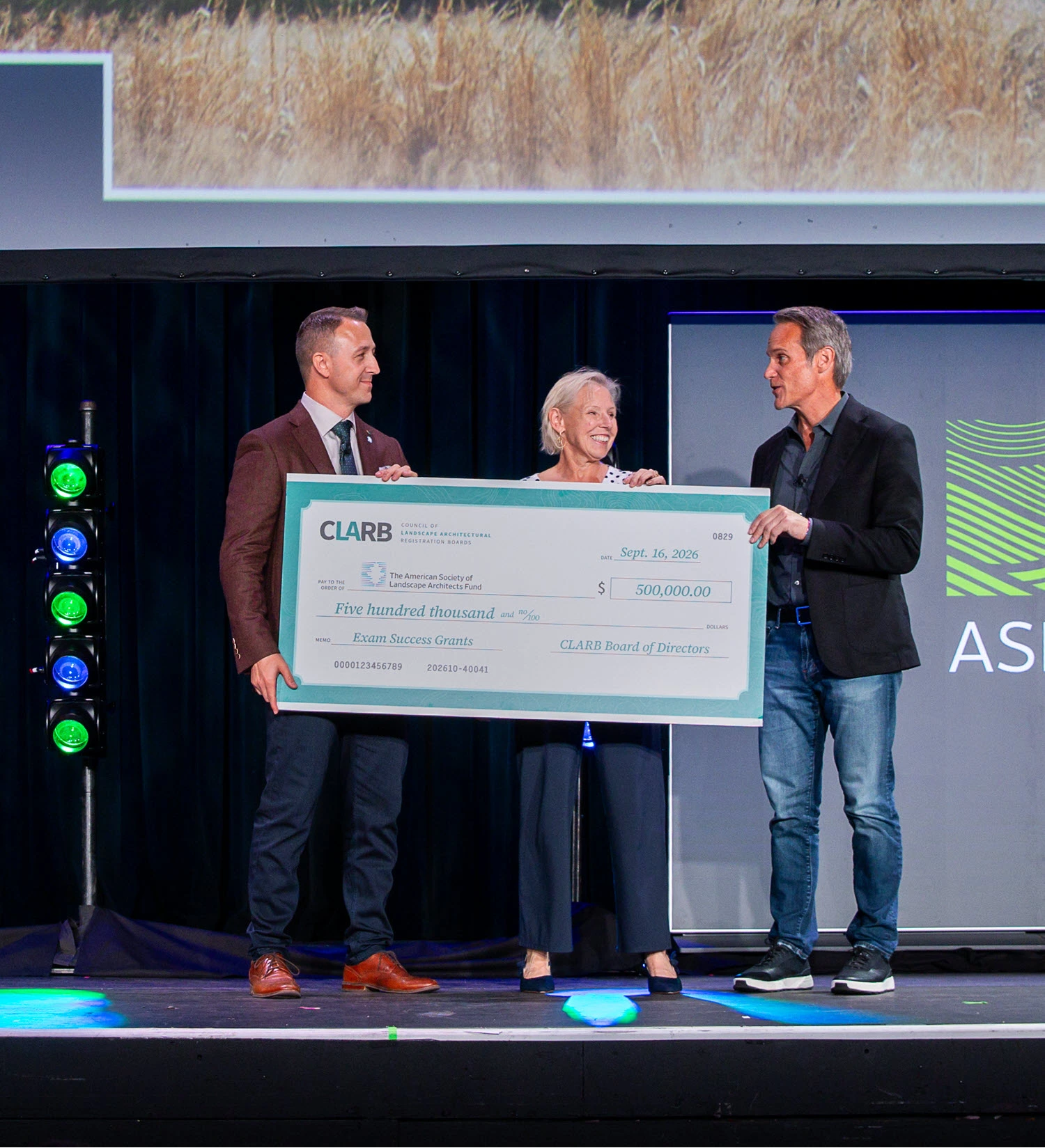 ASLA President Brad McCauley accepts the $500,000 grant check from CLARB President Allison Fleury and CLARB CEO Matt Miller