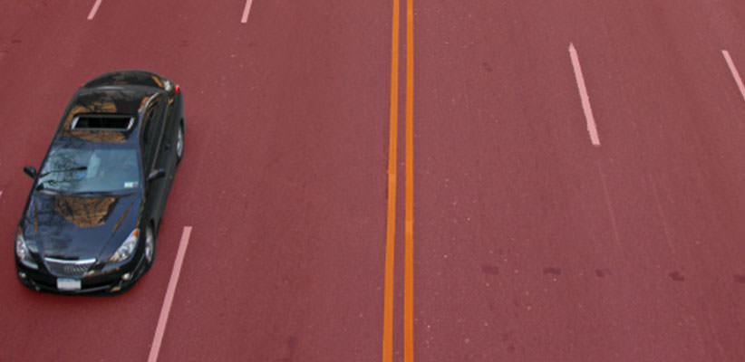 Single car on a road on which a red overlay appears